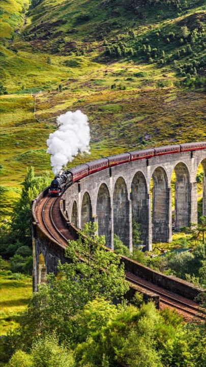 A steam train crossing the Glenfinnan Viaduct
