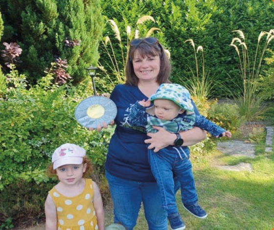 Mary Ritchie and her children with her Accumulator Challenge Medal