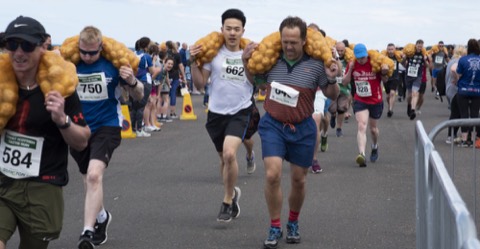 Runners carrying sacks of potatoes in the Great Scottish Tattie Run